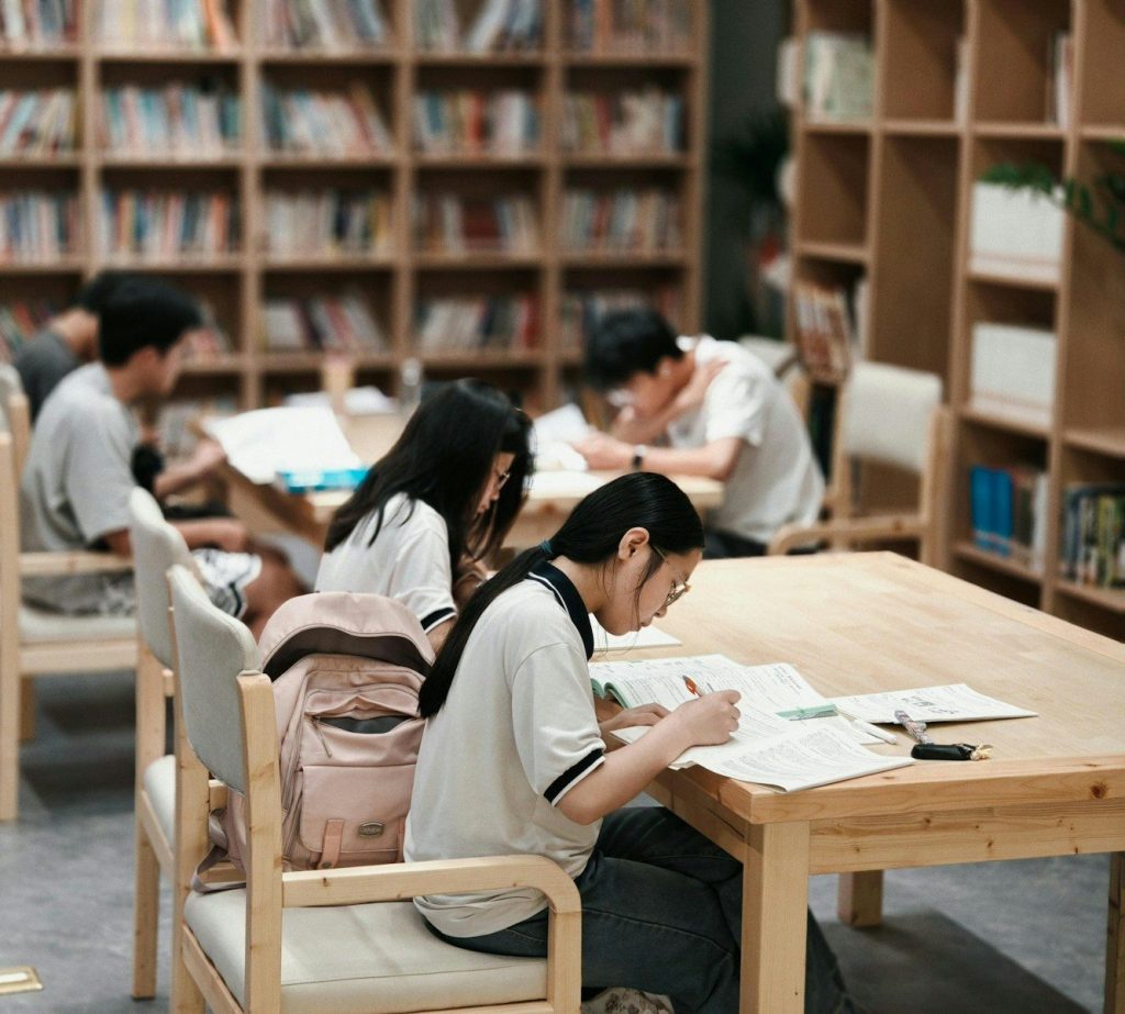 Students studying at tables in a library
