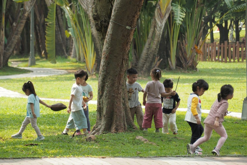 Children playing together in a grassy park