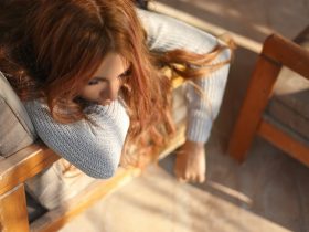 woman sleeping on brown armchair