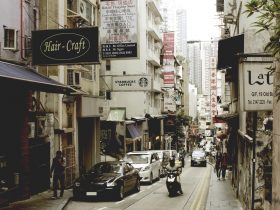 cars parked on sidewalk near buildings during daytime