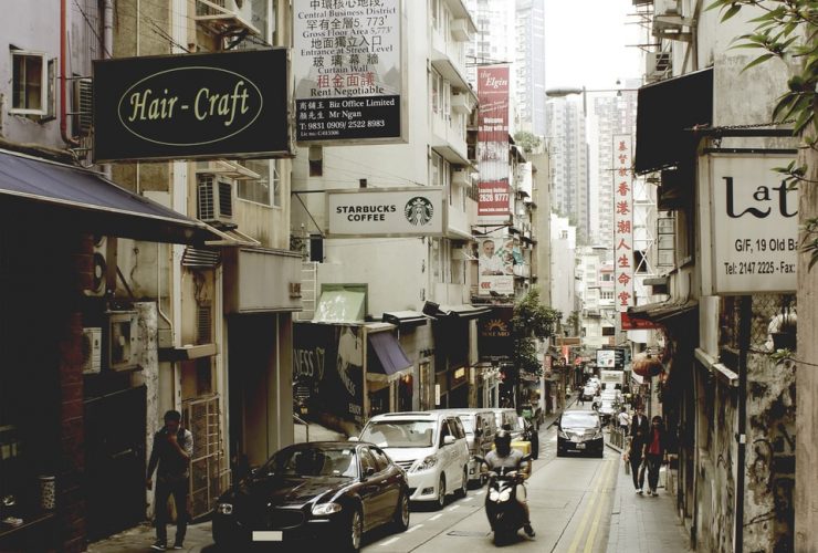 cars parked on sidewalk near buildings during daytime