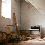 brown wooden armchair beside white wall