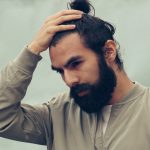 man holding his black hair