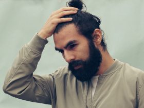man holding his black hair