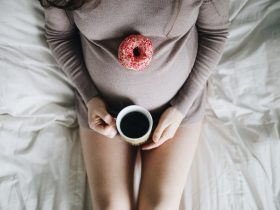 woman holding cup of coffee