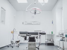 black and white hospital bed in the middle of interior building