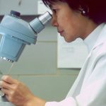 man in white dress shirt holding gray and silver steel tool