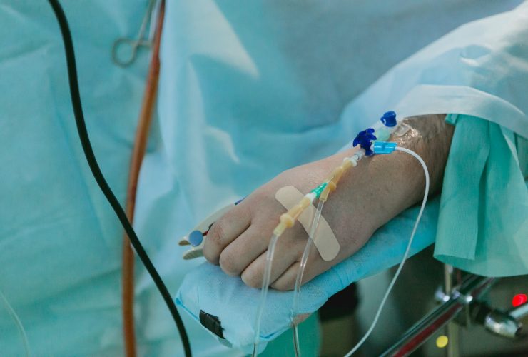 a person in a hospital bed with an iv