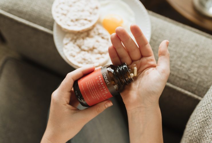 person holding red bottle