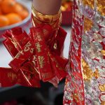 a close up of a person holding a red ribbon