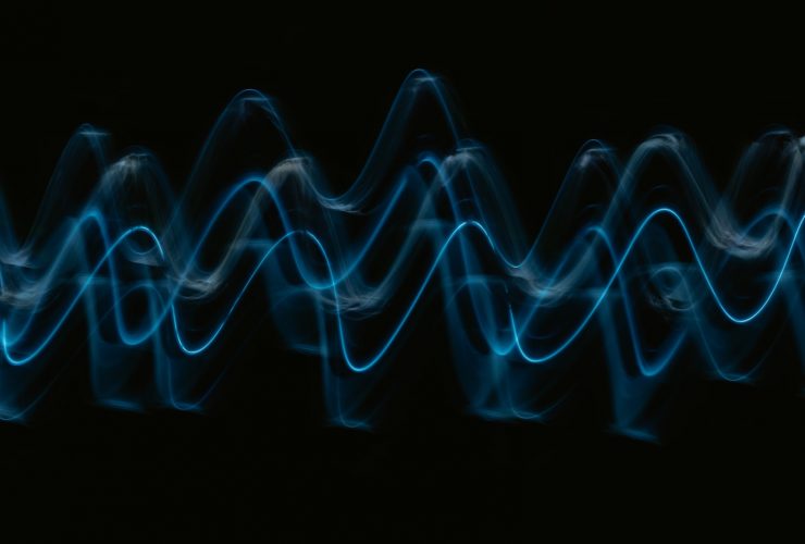 a black background with a blue wave of light