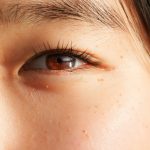 a close up of a woman's brown eye