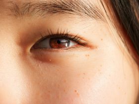 a close up of a woman's brown eye