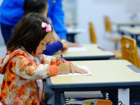 toddler sitting on desk