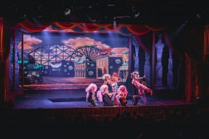 crowd of people watching a stage performance in the theater