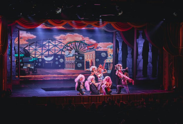 crowd of people watching a stage performance in the theater