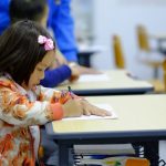 toddler sitting on desk