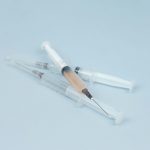 white and clear plastic syringe