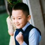 boy wearing blue waistcoat and dress shirt