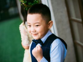 boy wearing blue waistcoat and dress shirt