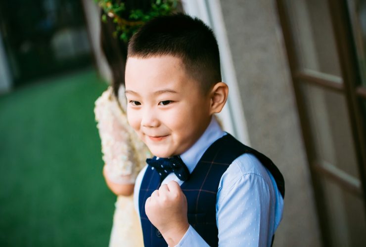 boy wearing blue waistcoat and dress shirt