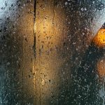 a wet window with a traffic light on it