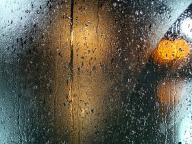 a wet window with a traffic light on it
