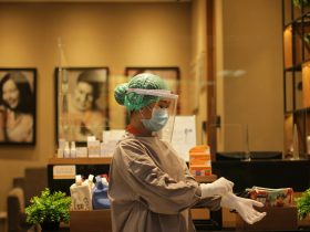 person in white dress shirt wearing green and white hat