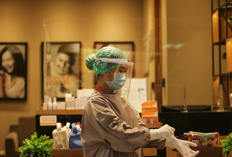 person in white dress shirt wearing green and white hat