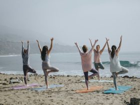 five woman standing on seashore