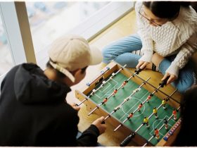man and woman playing foosball table