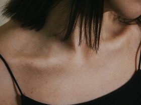 a close up of a woman wearing a black top