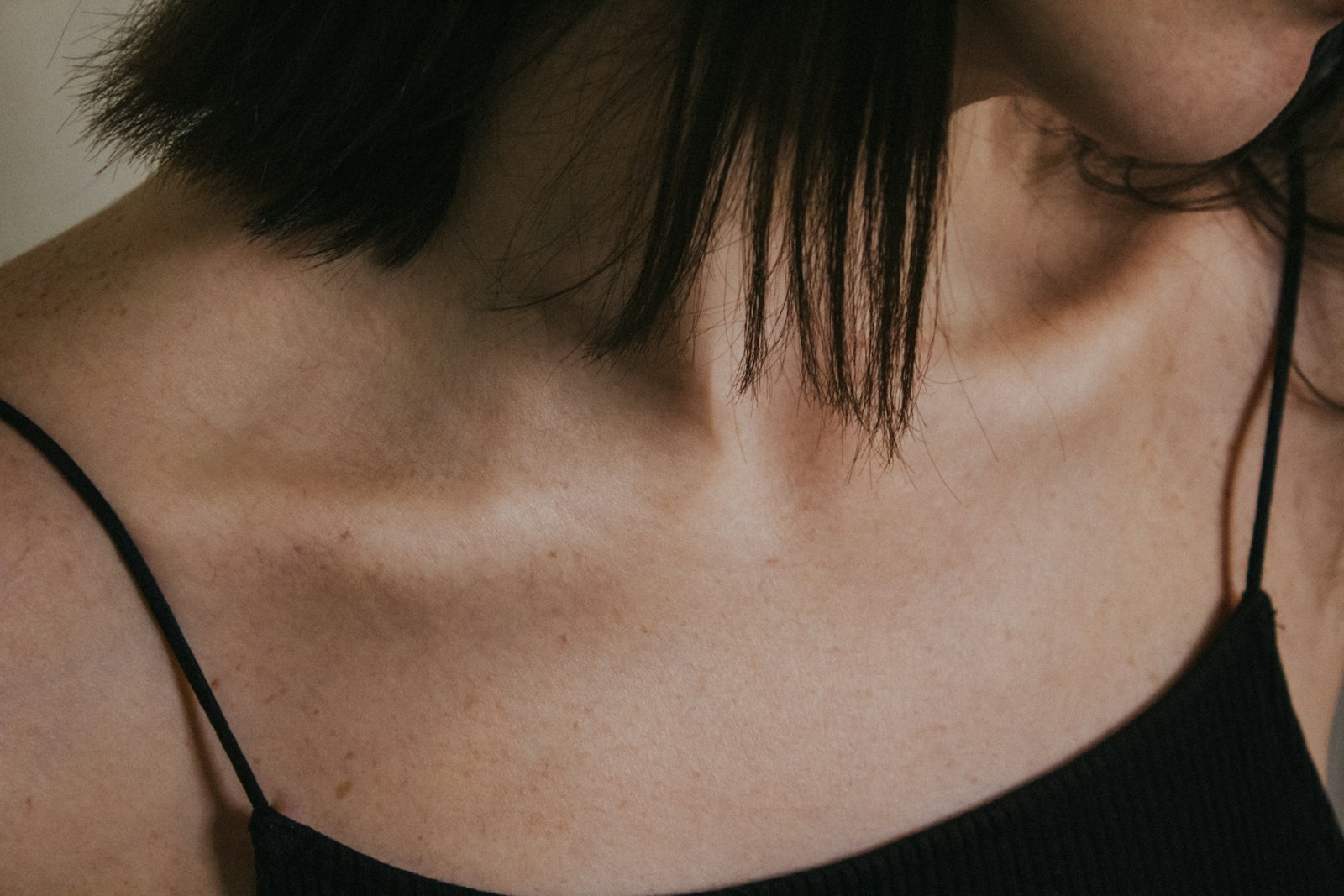 a close up of a woman wearing a black top