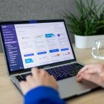 a person typing on a laptop on a table