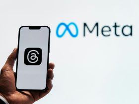 a person holding up a cell phone in front of a sign