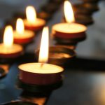 lighted candles on black metal candle holder