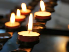 lighted candles on black metal candle holder