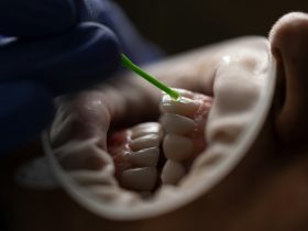a person holding a green tube