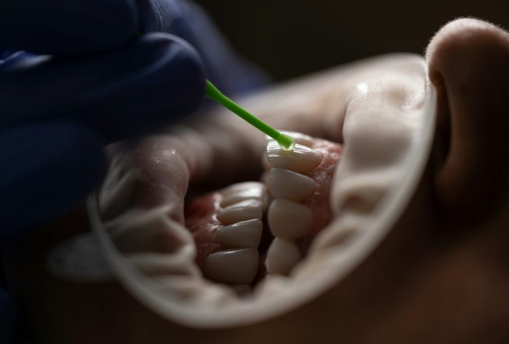 a person holding a green tube