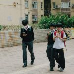 a group of young people walking down a street