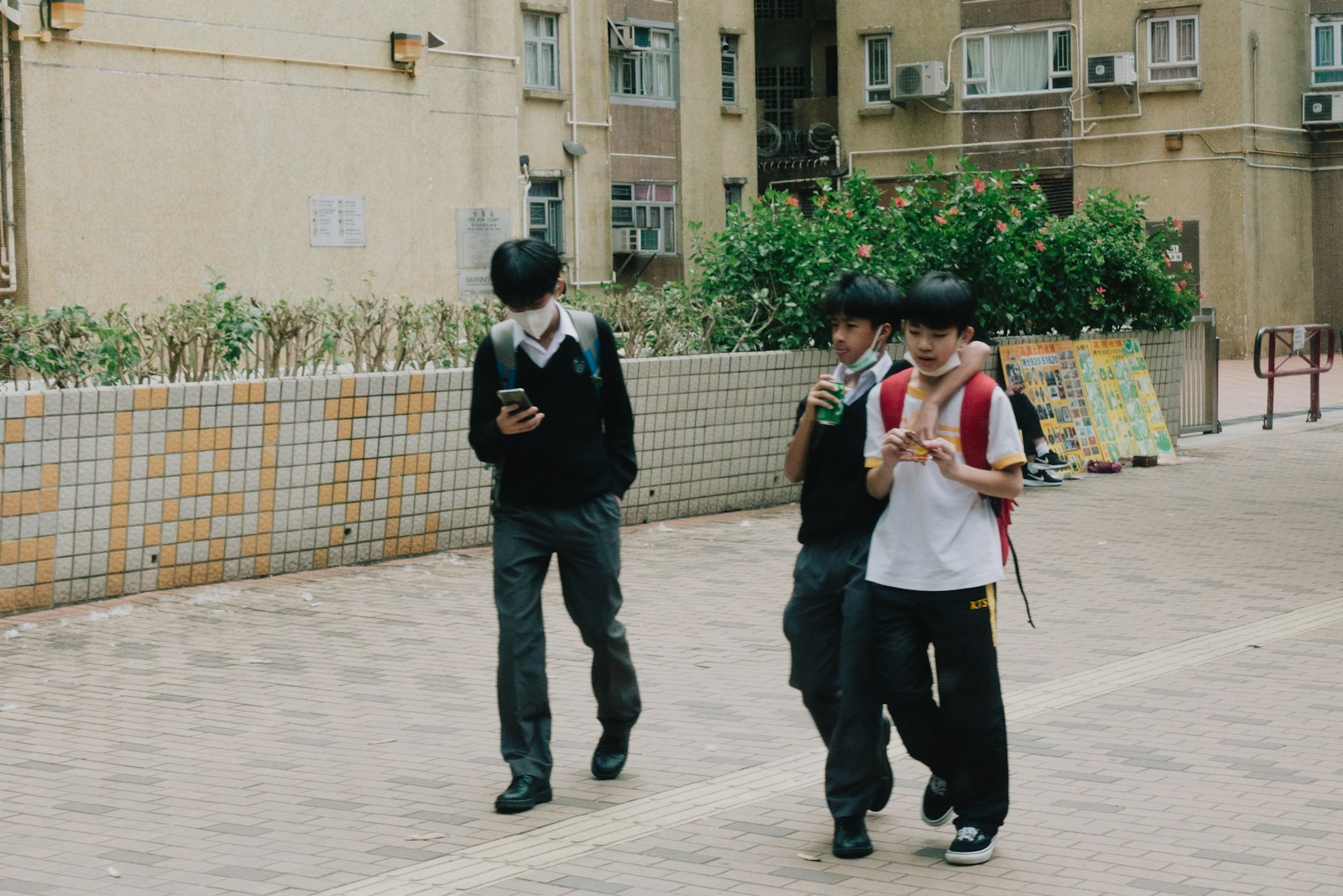 a group of young people walking down a street