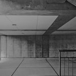 Underneath of a concrete structure, in black and white.