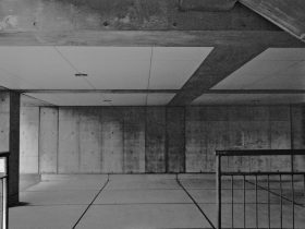 Underneath of a concrete structure, in black and white.