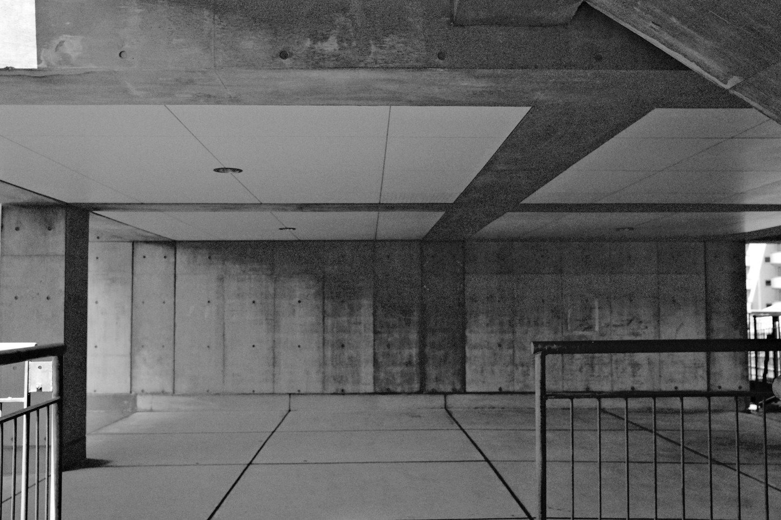 Underneath of a concrete structure, in black and white.