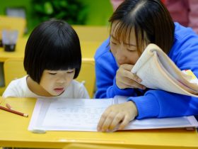 woman teaching girl
