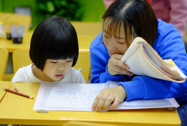 woman teaching girl
