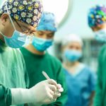 A group of doctors standing around each other